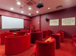 Cinema room at Redvers Tower equipped with a large screen and cozy seating for movie nights.