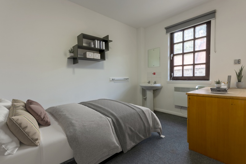 Modern student bedroom at Don Street residence hall accommodation. Includes bed, desk, chair, storag