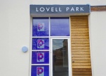 The entrance of Lovell Park Apartments with Primo Property Management branding