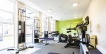 On-site gym at Lovell Park Apartments with various exercise equipment