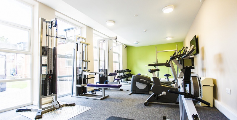 On-site gym at Lovell Park Apartments with various exercise equipment