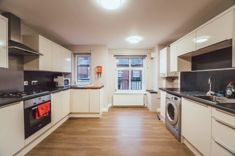 chancellors court manchester Spacious kitchen with white cabinetry with windows