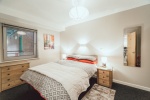 Mayfair Court Modern bedroom with a double bed, two bedside tables, and soft lighting