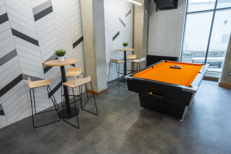 Games area with a pool table and gaming consoles at Oxford House student accommodation