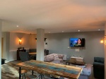 A contemporary communal dining room with stylish furniture and kitchen facilities atThe Warehouse Ap