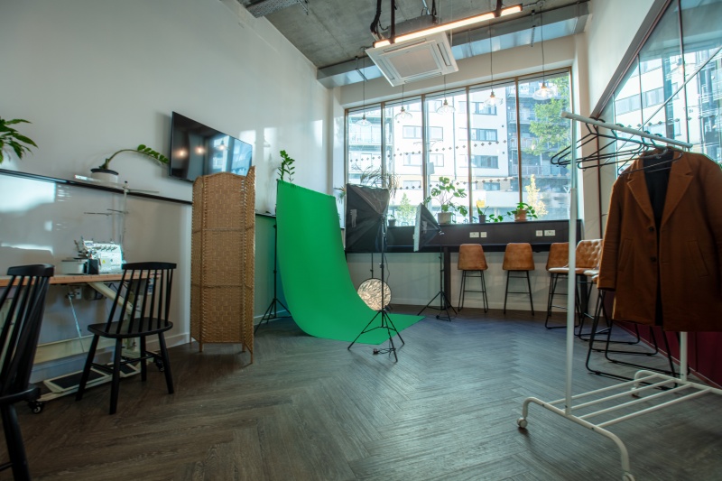 Creative space space with a green screen, lighting, and workstations at The Valentine