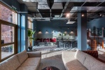 Bright social space with seating and plants at The Valentine student accommodation