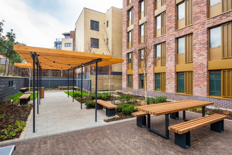 Landscaped courtyard with seating and greenery at The Valentine