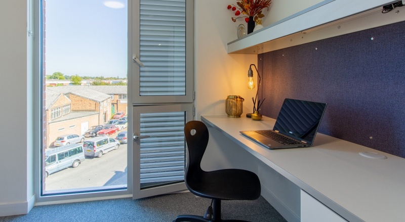 Study desk and window Ensuite bedroom with bed, study area, and wardrobe, at The Union in The Union 