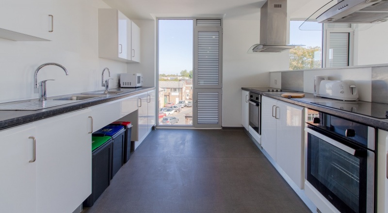 Modern shared kitchen facilities at The Union, showcasing appliances and ample space for cooking and