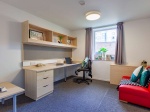 ensuite bedroom at The Green, featuring a double bed, desk area