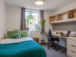 Cozy ensuite bedroom at The Green, featuring a double bed, desk area, and personal bathroom