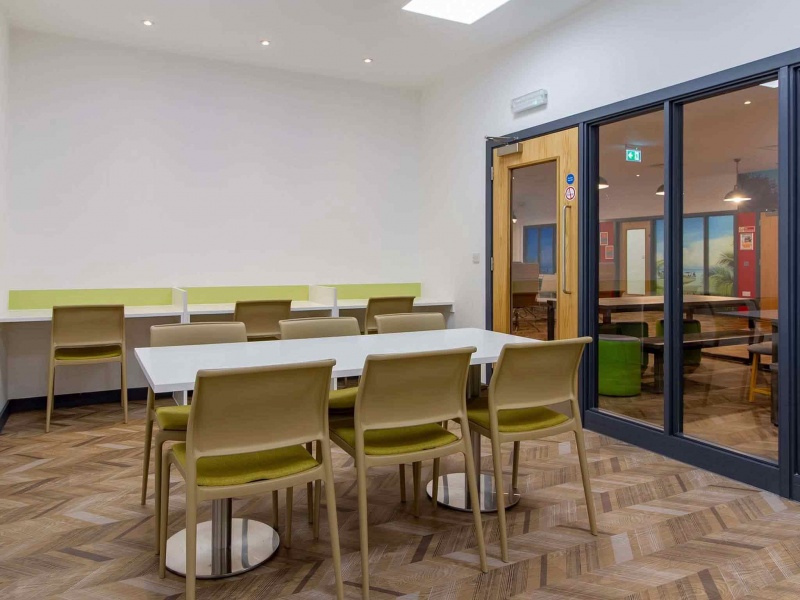 Bright study room with desks and chairs at Plymouth Cross House