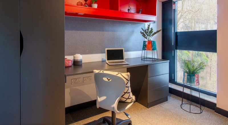 Spacious study area at Béton House student accommodation in Sheffield, featuring desks and natural l