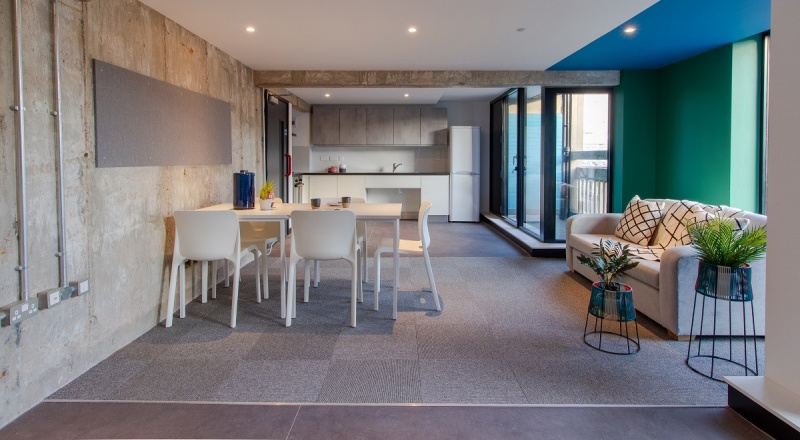 Modern communal area at Béton House in Sheffield with comfortable seating and large windows