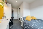 Modern en-suite room at Central Living Exeter with a comfortable bed and study area.