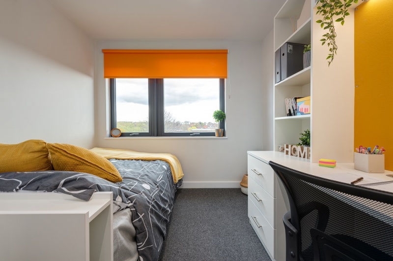 Cozy bedroom with ample storage space at Central Living student accommodation in Exeter