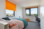 Cozy bedroom with ample storage space at Central Living student accommodation in Exeter