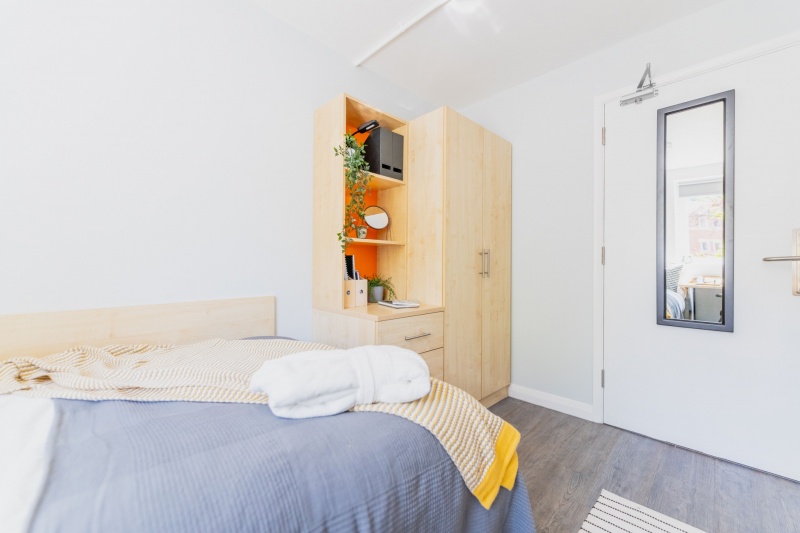 Student bedroom at Beech Gardens, Birmingham, features a bed, desk, and storage