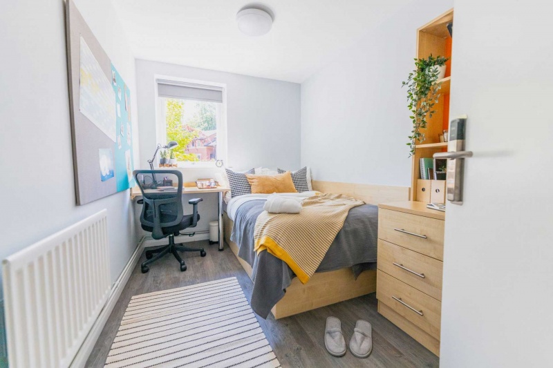 view of a bright student room at Beech Gardens with a single bed, study desk, and ergonomic chair