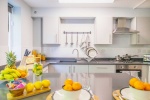 Modern kitchen at Beech Gardens with sleek countertops, dining setup, and vibrant décor