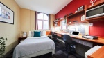 Modern student studio at Burges House Coventry. Includes bed, desk, chair, storage and has a window.