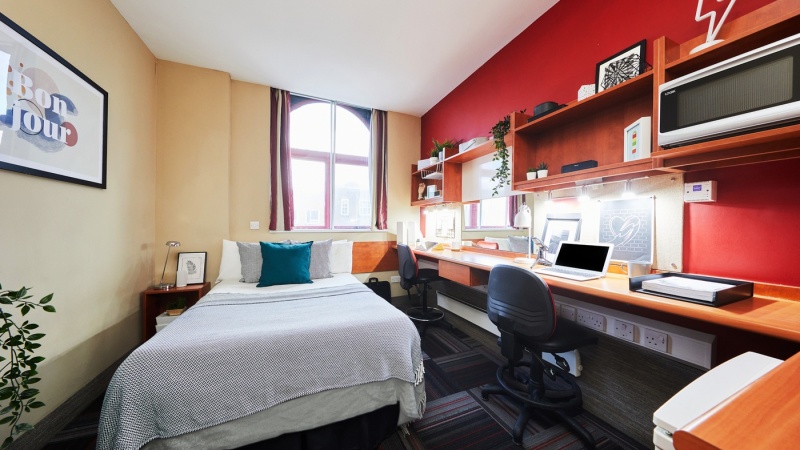 Modern student studio at Burges House Coventry. Includes bed, desk, chair, storage and has a window.