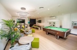 Stylish common area with pool table and seating in Crosstrend House