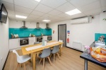 Modern communal kitchen area in Crosstrend House