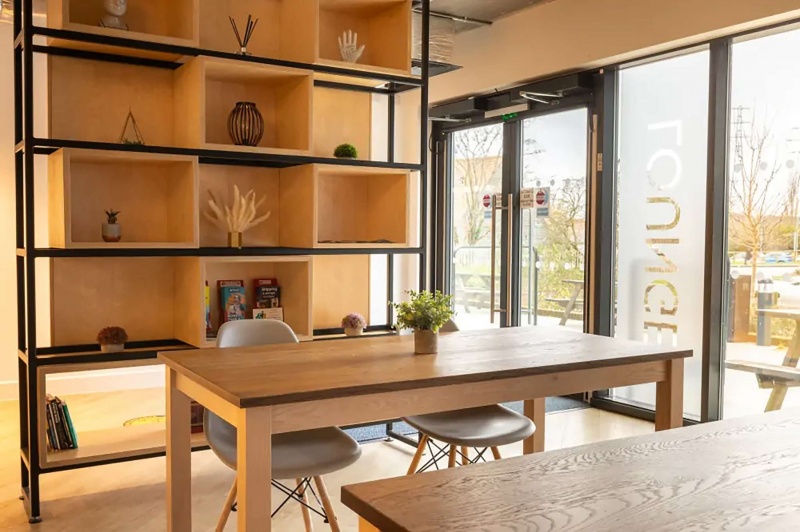 A versatile common room with lounge seating and study desks, providing a comfortable space for relax