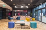 Stylish seating area at Onyx Birmingham with yellow and blue chairs