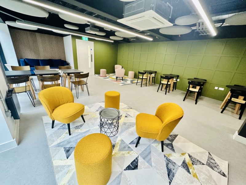 Common area at The Nest with colorful chairs at The Nest