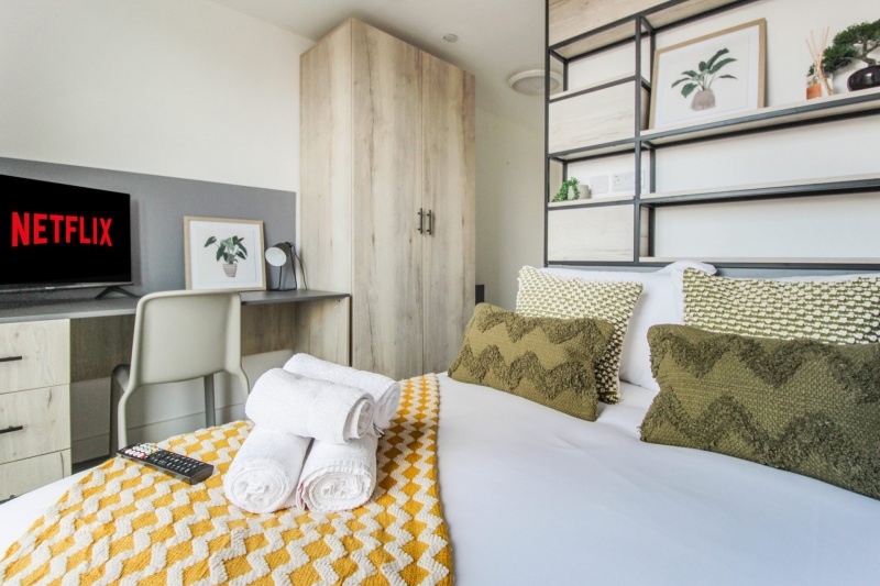 Modern bedroom with ample storage space at The Nest student accommodation