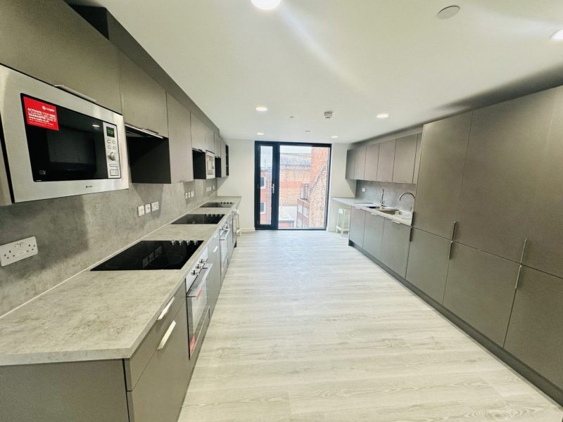 Fully equipped kitchen in a student apartment at The Nest