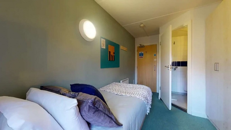 Comfortable ensuite bedroom with bed, desk, and storage at Creek Court in London
