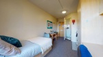 Ensuite bedroom with bed, desk, and storage at Creek Court in student accommodation London
