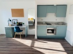 View of the study  desk, kitchenette and storage at The Nest in Nottingham