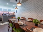 A modern shared kitchen space with a dining table, appliances, and contemporary design.