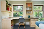 Comfortable bedroom at Snow Island student accommodation Huddersfield with study desk and shelving