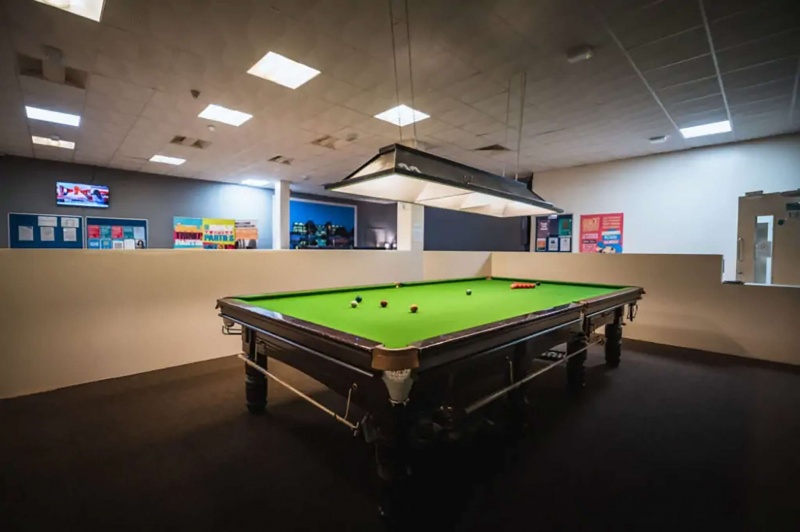 Pool table in a recreational area at The Junxion student housing