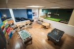 Game room with foosball, pool tables, and seating at The Junxion.