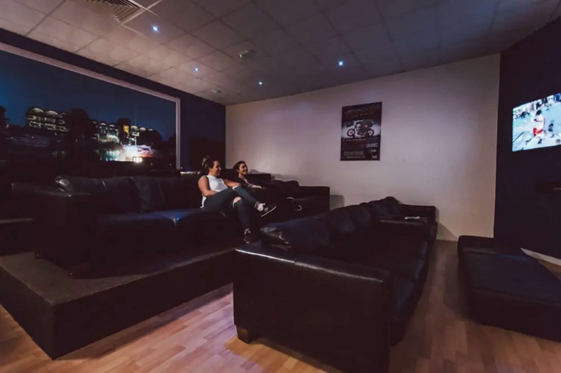 The Junxion Cinema room; Darkened cinema room with leather seating and a screen