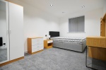 Comfortable bedroom with bed, desk, and storage at at Beechwood House and Gardens 