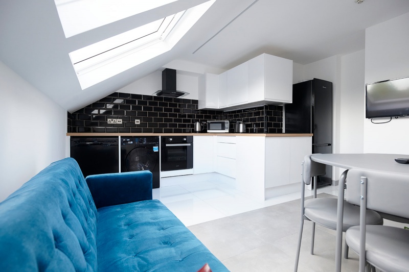 communal kitchen with blue sofa at Beechwood House and Gardens 