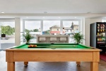 A modern game room with a pool table and a vending machine, located in the Saw Mill student accommod