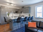 common kitchen with a large high table for eating and sofas, Preston Accommodation