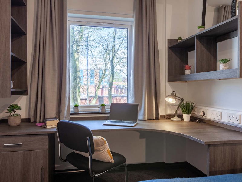 Study table in a bright corner, single room