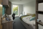 Compact student bedroom with a bed, desk, and window in Graystacks, Nottingham.