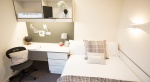 Cozy bedroom at Powis Place, Aberdeen with a study desk, bed, and modern decor.