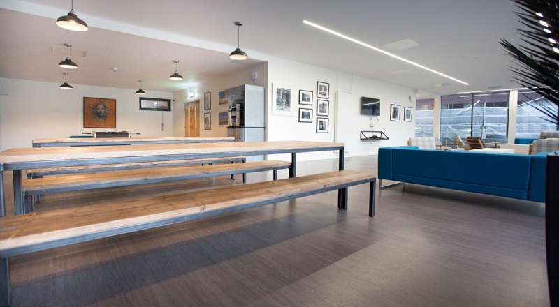 Communal dining area at Powis Place, Aberdeen with long wooden benches and modern lighting